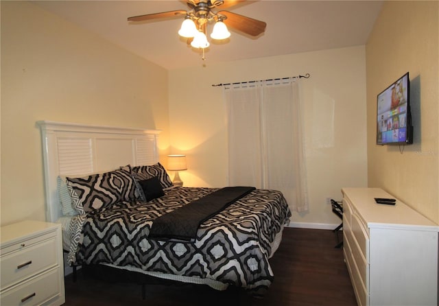 bedroom with dark hardwood / wood-style floors and ceiling fan