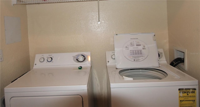 clothes washing area with washing machine and dryer