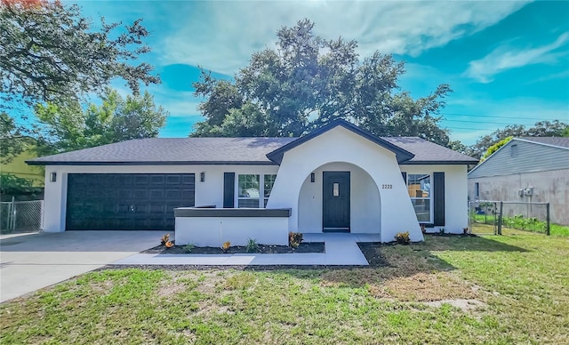 ranch-style home with a garage and a front yard