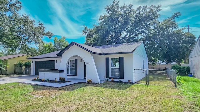 view of front of house with a garage and a front yard