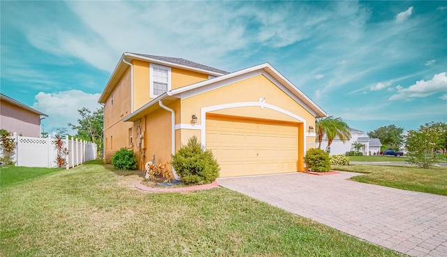 view of front of home with a garage and a front lawn