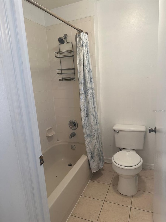 bathroom with shower / bathtub combination with curtain, toilet, and tile patterned floors