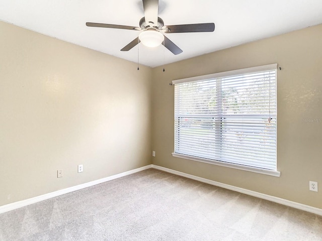 carpeted empty room featuring ceiling fan