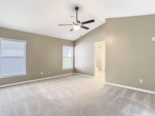 carpeted empty room with vaulted ceiling and ceiling fan