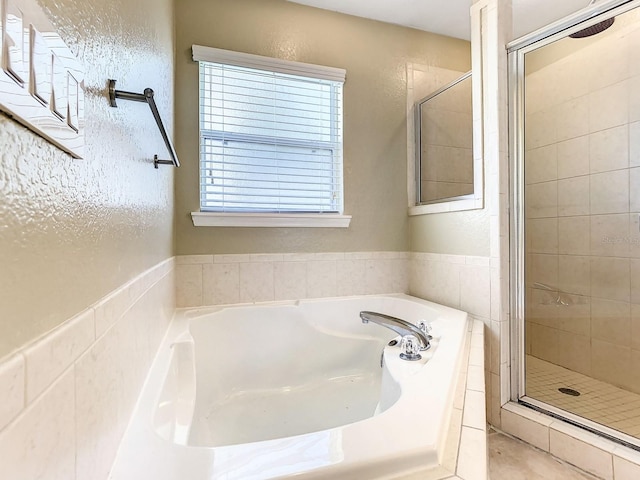 bathroom featuring independent shower and bath