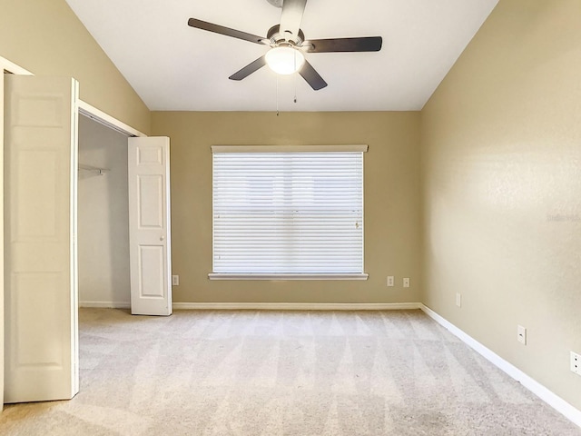 unfurnished bedroom featuring light colored carpet, a closet, and ceiling fan