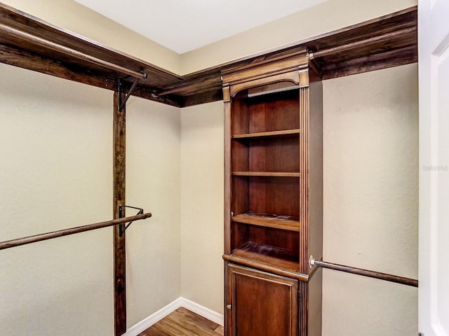 spacious closet featuring hardwood / wood-style flooring