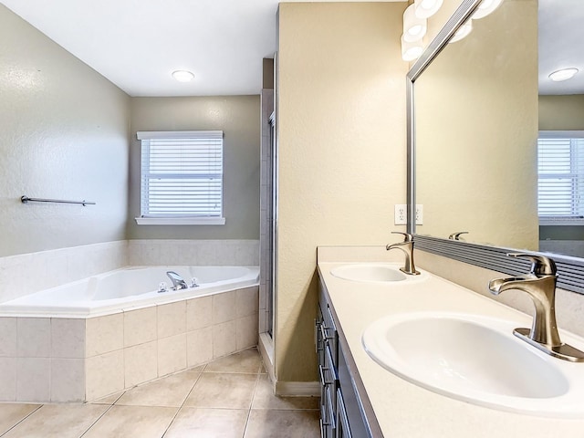 bathroom with vanity, tiled bath, and tile patterned floors