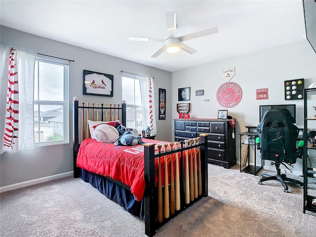 carpeted bedroom with a ceiling fan and baseboards