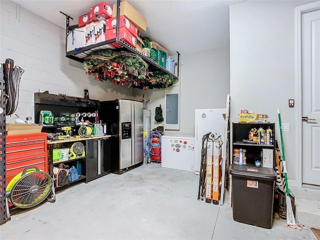 garage featuring fridge, stainless steel fridge, and electric panel