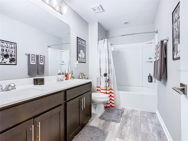 full bathroom featuring visible vents, a sink, toilet, and wood finished floors