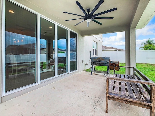 view of patio / terrace with ceiling fan, a grill, and fence