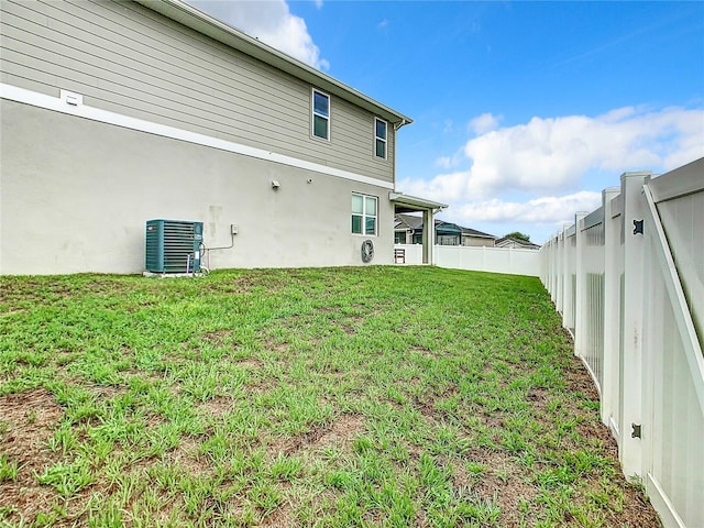 exterior space with central AC and a fenced backyard