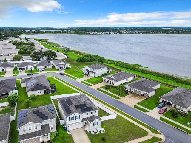 drone / aerial view with a residential view and a water view