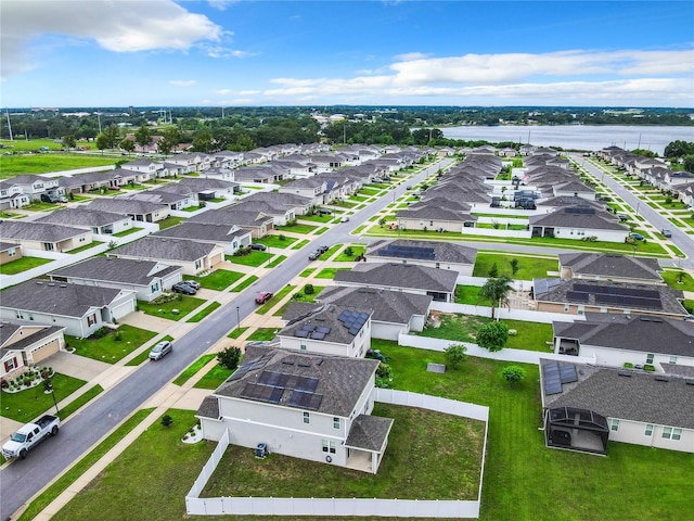 birds eye view of property with a water view and a residential view