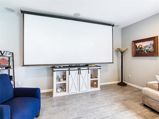 sitting room with baseboards and wood finished floors