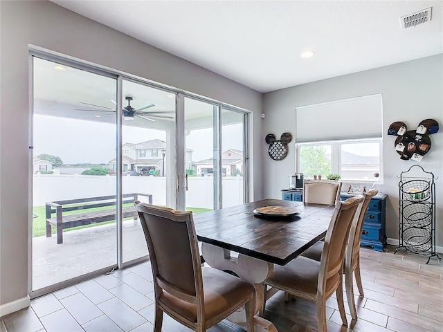 dining area featuring baseboards, visible vents, and ceiling fan