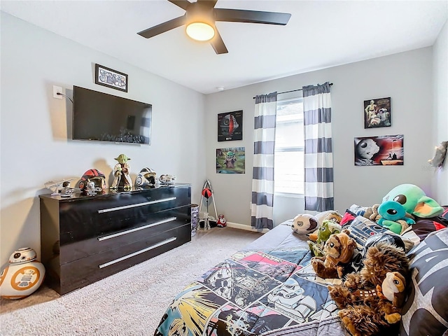 carpeted bedroom featuring ceiling fan and baseboards