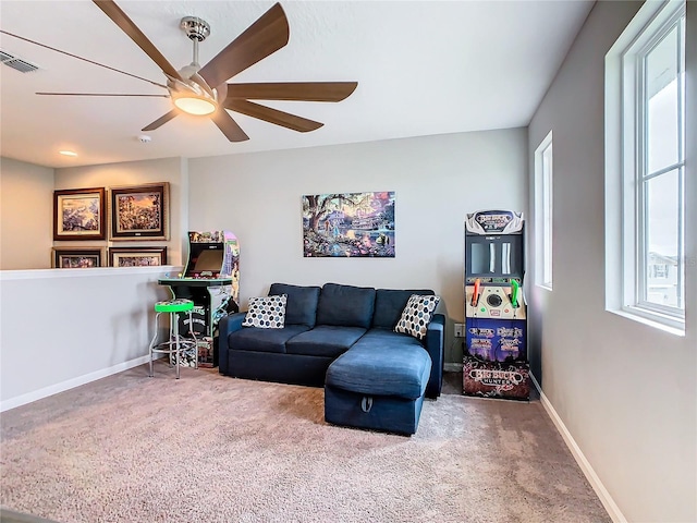 carpeted living area with visible vents, ceiling fan, and baseboards