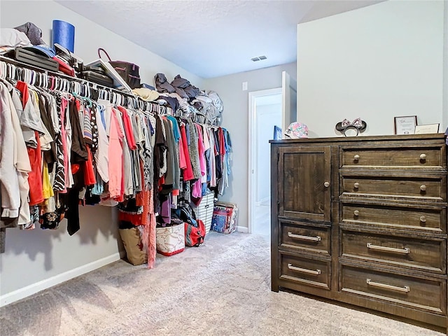 walk in closet featuring visible vents and carpet flooring