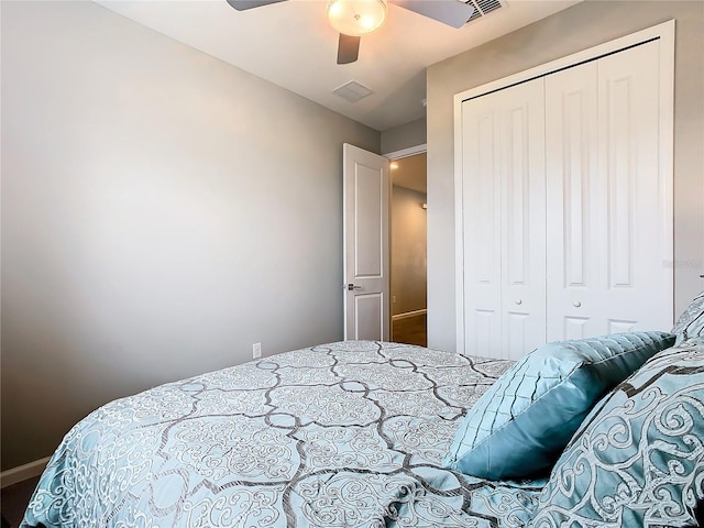 bedroom with a closet, visible vents, ceiling fan, and baseboards