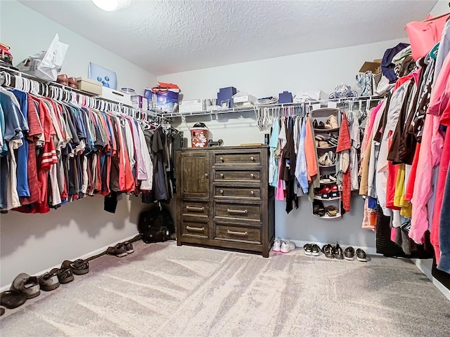 walk in closet featuring carpet