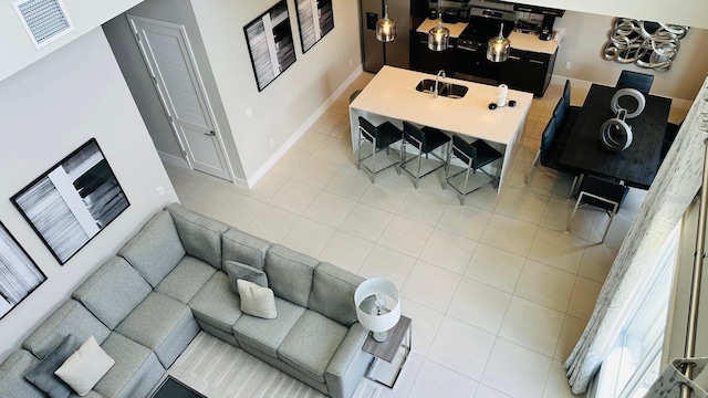 tiled living room with a towering ceiling