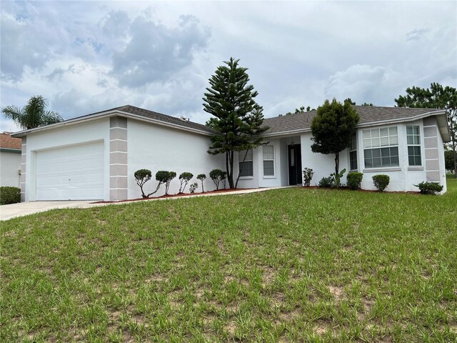 ranch-style home with a front lawn and a garage