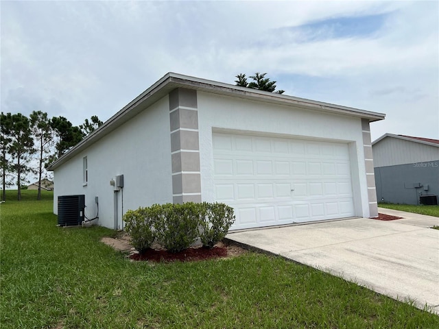 view of side of property with cooling unit, a yard, and a garage