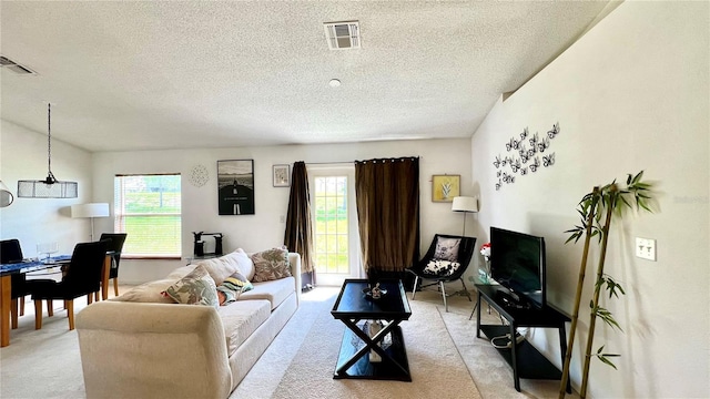 carpeted living room featuring a textured ceiling