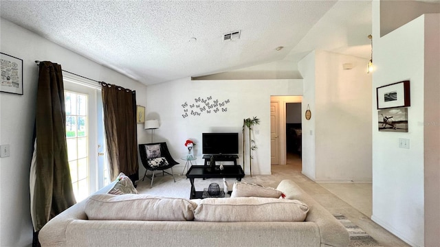 living room featuring lofted ceiling, light colored carpet, and a textured ceiling