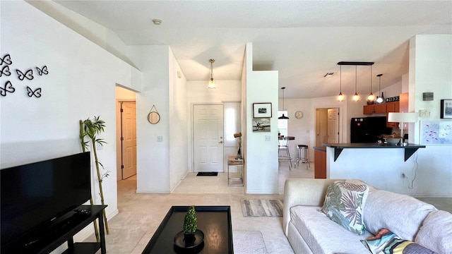 carpeted living room with lofted ceiling