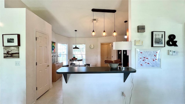 kitchen with pendant lighting, kitchen peninsula, and a breakfast bar area