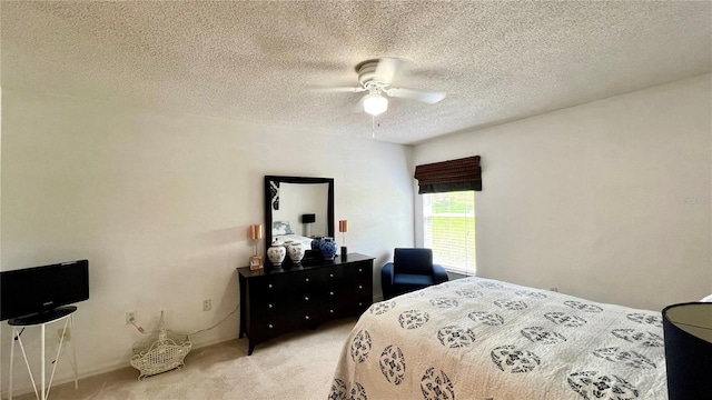 carpeted bedroom with ceiling fan and a textured ceiling