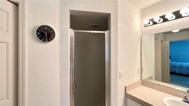 bathroom with an enclosed shower and vanity