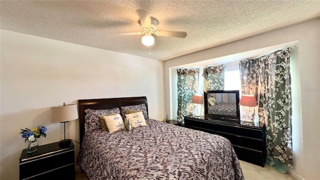 carpeted bedroom with ceiling fan and a textured ceiling