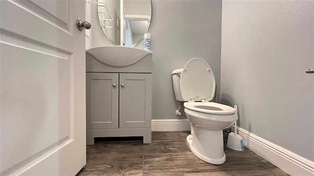 bathroom featuring vanity, hardwood / wood-style floors, and toilet