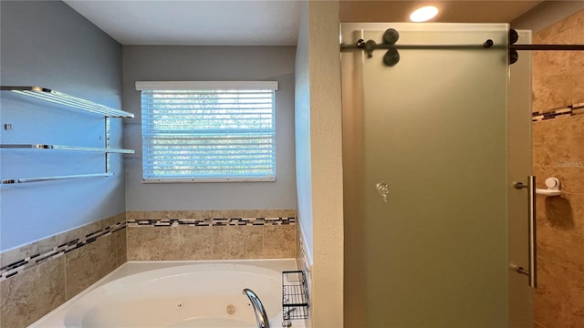 bathroom featuring shower with separate bathtub