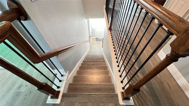 stairs with wood-type flooring