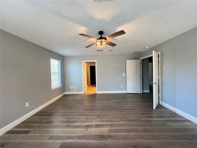 unfurnished bedroom with dark hardwood / wood-style flooring, ensuite bathroom, a textured ceiling, and ceiling fan