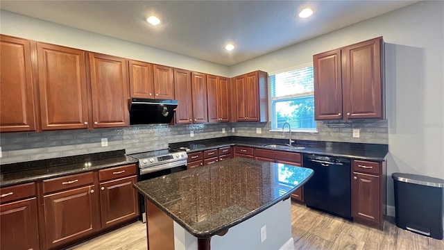 kitchen featuring sink, dark stone countertops, black dishwasher, extractor fan, and a kitchen island