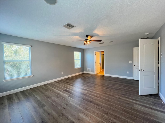 unfurnished room featuring ceiling fan, dark hardwood / wood-style floors, and a textured ceiling