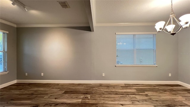 spare room with crown molding, rail lighting, a chandelier, and hardwood / wood-style flooring