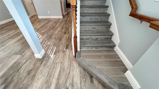 stairs with hardwood / wood-style flooring