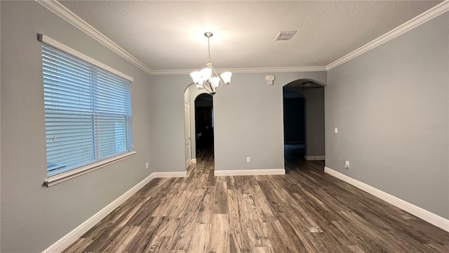 unfurnished dining area featuring dark hardwood / wood-style flooring, a notable chandelier, ornamental molding, and a textured ceiling