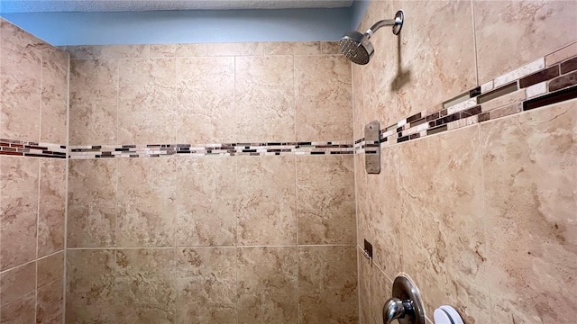 interior details with a tile shower