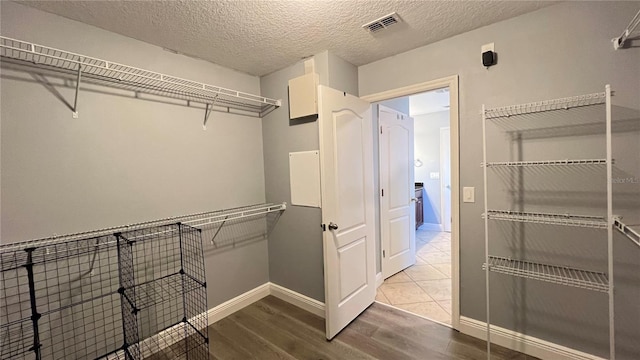 walk in closet with wood-type flooring