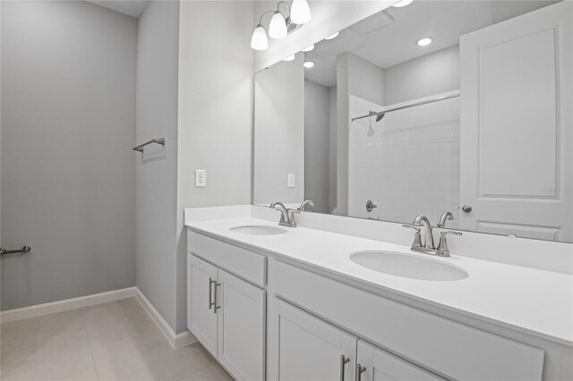 bathroom featuring vanity, tile patterned floors, and a shower