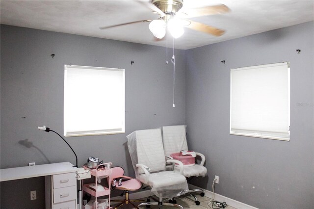 interior space with ceiling fan