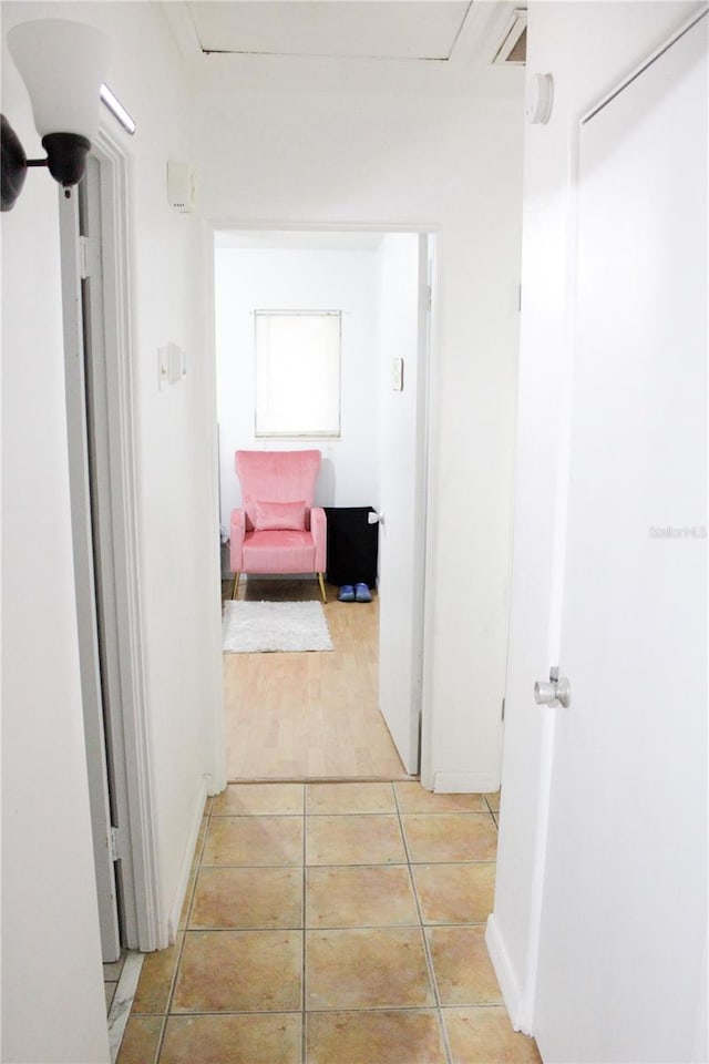 corridor with light tile patterned flooring